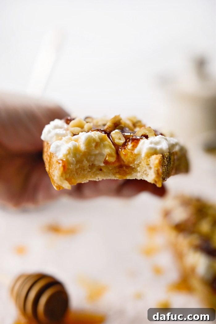 Honeyed Fig & Creamy Cottage Cheese Toast 2 Delicious Honey Fig Jam and Cottage Cheese Toast on a wooden board, ready to be enjoyed.