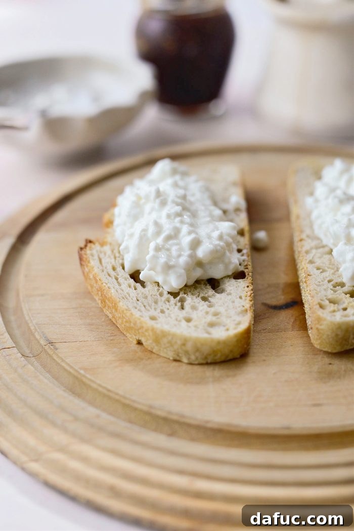 Honeyed Fig & Creamy Cottage Cheese Toast 5 Spreading creamy cottage cheese onto a slice of toasted sourdough bread.