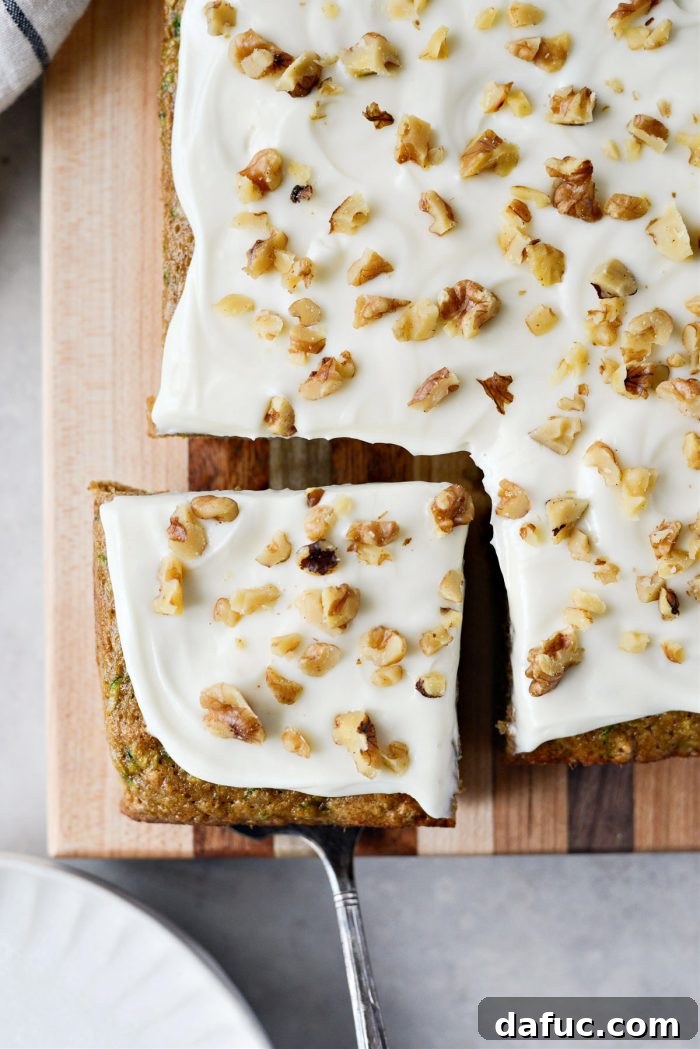Lush Zucchini Cake with Cream Cheese Frosting 2 Zucchini Cake with Cream Cheese Frosting - a slice of moist cake topped with creamy white frosting