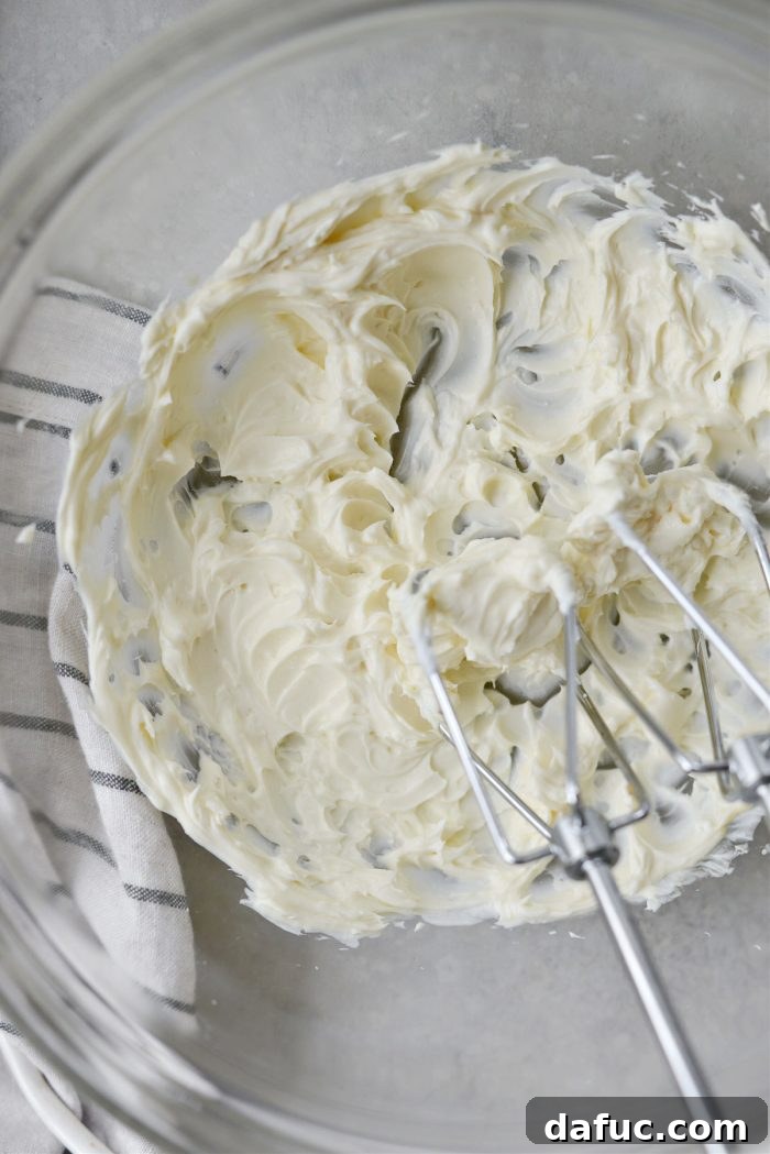Lush Zucchini Cake with Cream Cheese Frosting 13 Beating cream cheese, butter, and vanilla extract until smooth