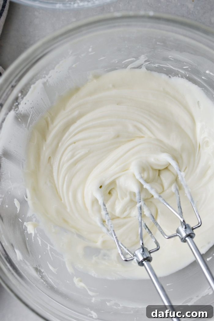 Lush Zucchini Cake with Cream Cheese Frosting 16 Adding a splash of milk to thin the cream cheese frosting to desired consistency