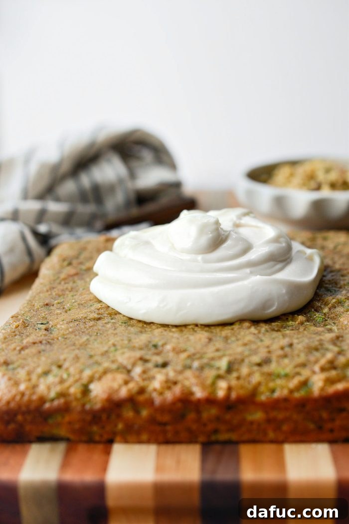 Lush Zucchini Cake with Cream Cheese Frosting 18 Applying cream cheese frosting onto the Zucchini Cake
