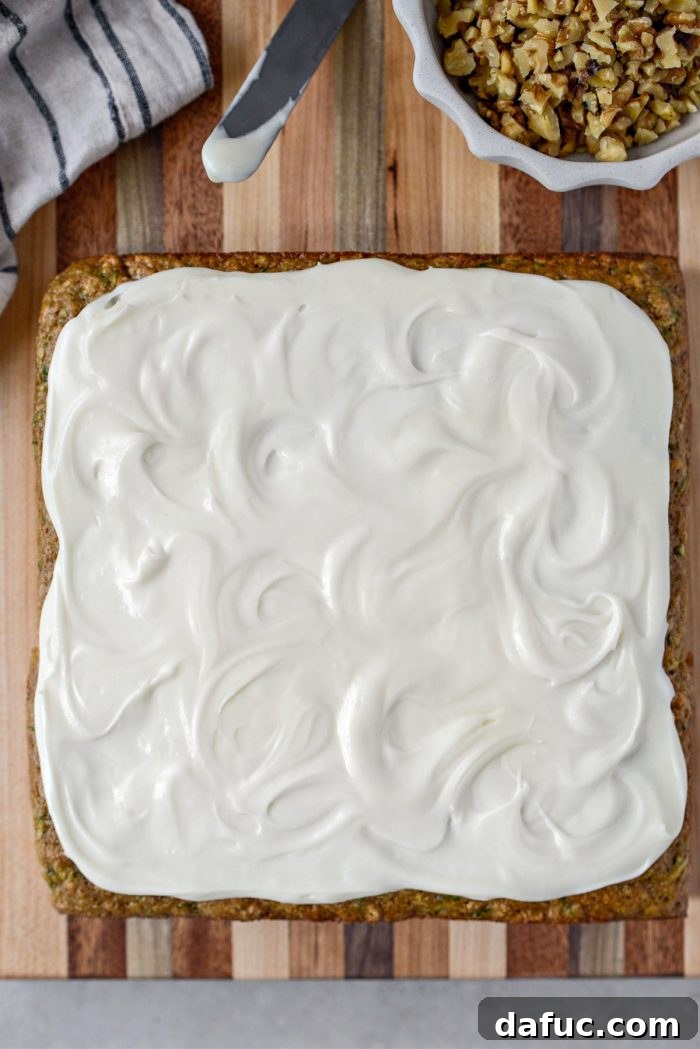Lush Zucchini Cake with Cream Cheese Frosting 19 Spreading cream cheese frosting evenly over the Zucchini Cake with an offset spatula