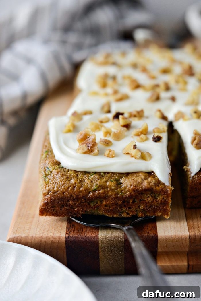 Lush Zucchini Cake with Cream Cheese Frosting 21 A beautifully frosted Zucchini Cake, ready to be sliced and served