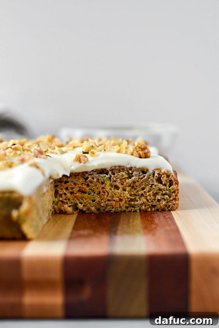 Lush Zucchini Cake with Cream Cheese Frosting 22 A close-up of a slice of Zucchini Cake with Cream Cheese Frosting, showing its moist texture