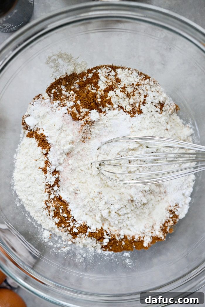 Lush Zucchini Cake with Cream Cheese Frosting 6 Measuring and whisking dry ingredients in a medium bowl