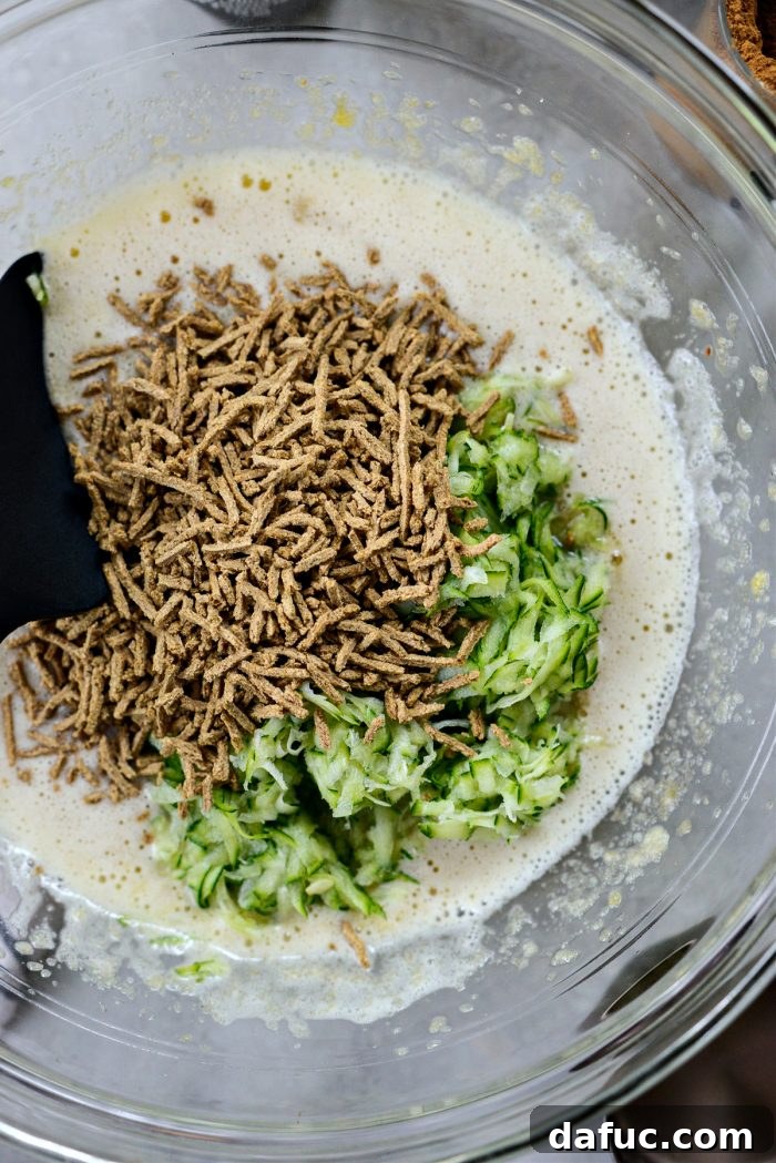 Lush Zucchini Cake with Cream Cheese Frosting 8 Beating in grated zucchini and all-bran cereal into the wet ingredients
