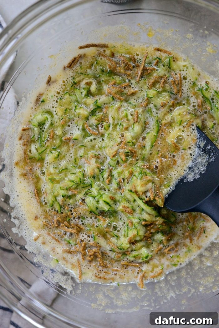 Lush Zucchini Cake with Cream Cheese Frosting 9 Stirring the cake batter with a rubber spatula