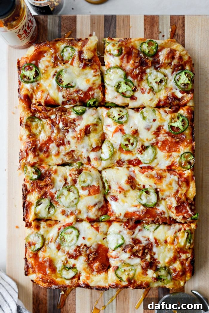 Bacon Jalapeño Focaccia Pizza being cut into slices