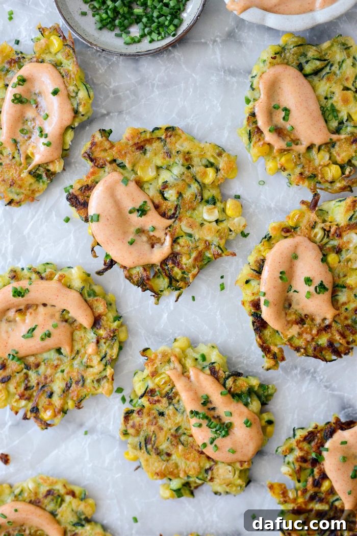 Crispy Zucchini Corn Fritters 2 Crispy Zucchini Corn Fritters with Yum Yum Sauce on a plate
