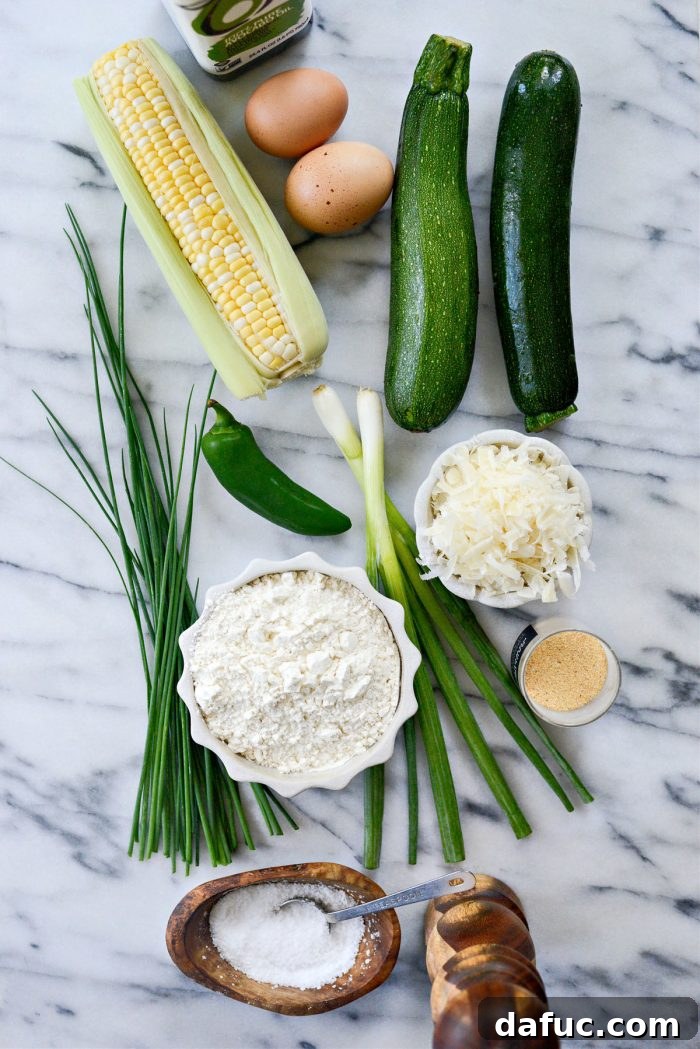Crispy Zucchini Corn Fritters 4 Fresh ingredients laid out for Zucchini Corn Fritters recipe preparation