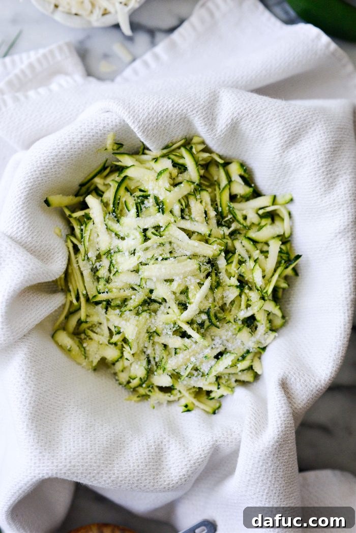 Crispy Zucchini Corn Fritters 6 Grated zucchini seasoned with kosher salt in a kitchen towel