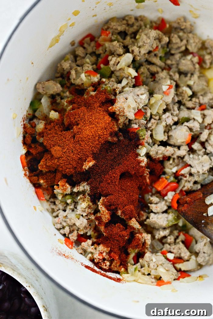 Stirring spices into the chili mixture