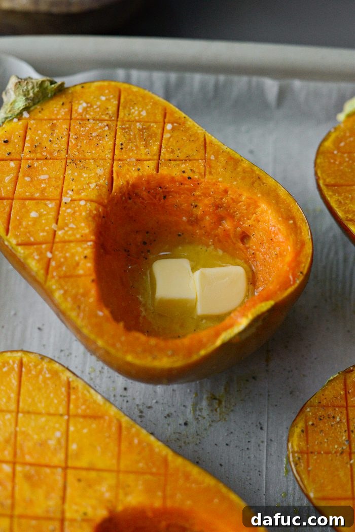 Flipping roasted squash and adding butter to each half.