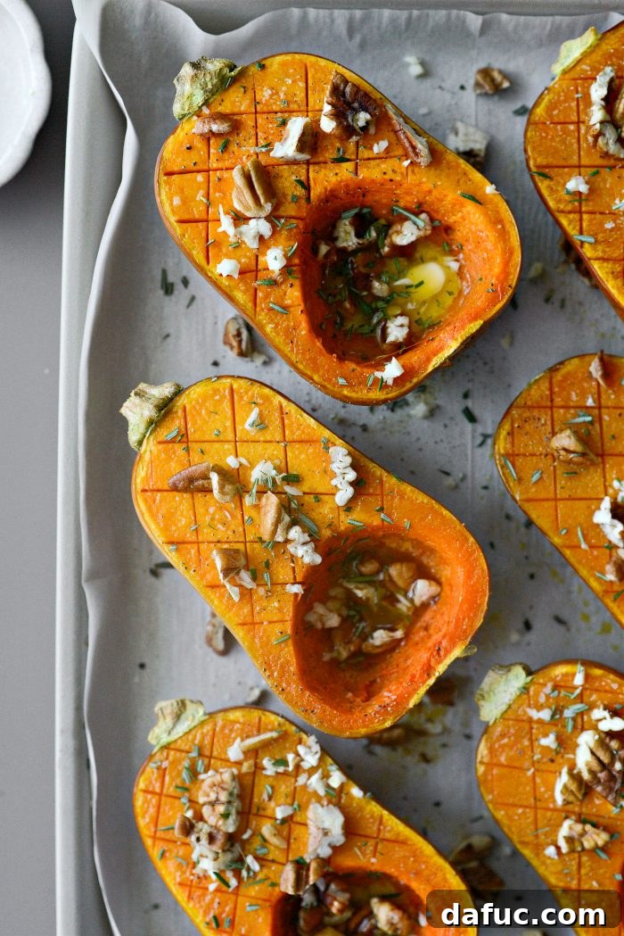 Sprinkling chopped pecans, garlic, and rosemary onto roasted honeynut squash.