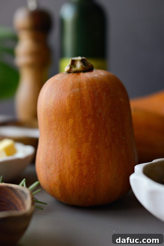 Close-up of fresh honeynut squash on a wooden board.