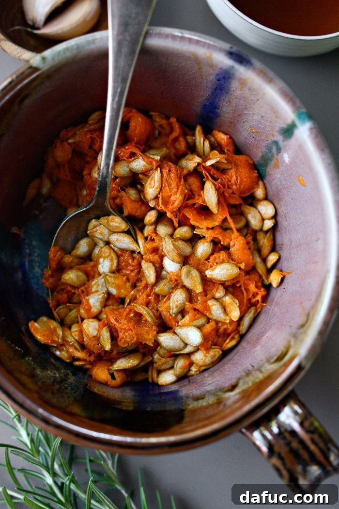 Honeynut squash seeds in a small bowl after scooping.