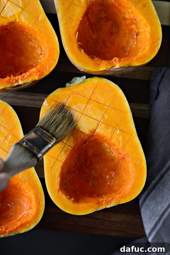Scoring the cut side of honeynut squash halves before roasting.