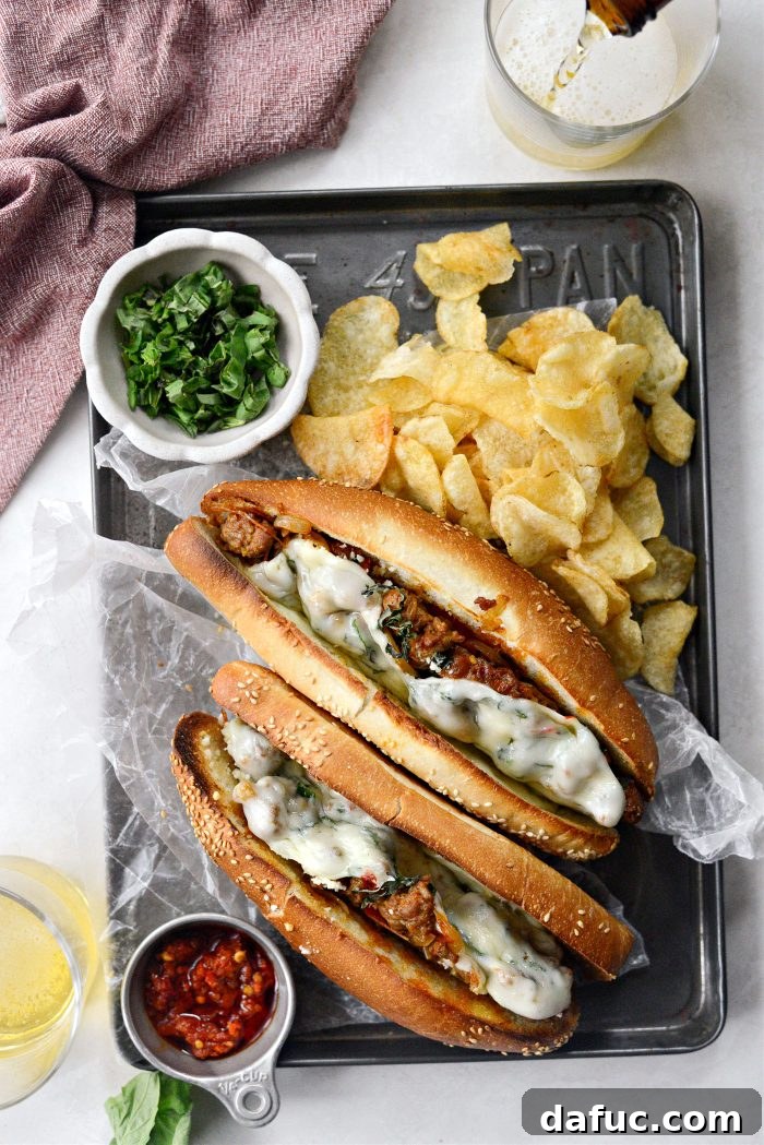 A perfectly broiled Spicy Italian Sausage Sub, cheese melted and filling overflowing, ready to be served.