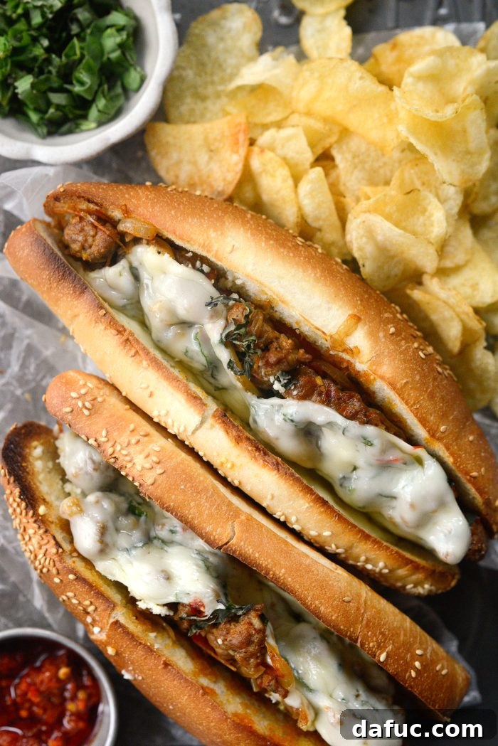 Another mouthwatering close-up of a Spicy Italian Sausage Sub, showcasing the rich filling and melted cheese.