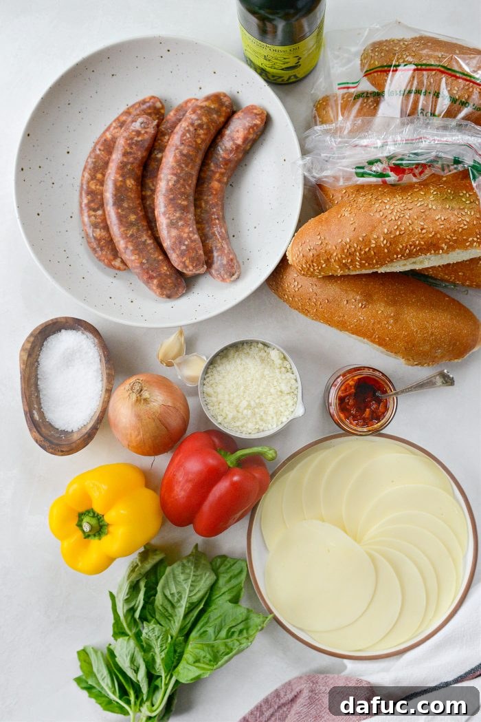 A collection of fresh ingredients laid out on a cutting board, including spicy Italian sausage links, bell peppers, onions, garlic, basil, and cheeses, ready for making Spicy Italian Sausage Subs.