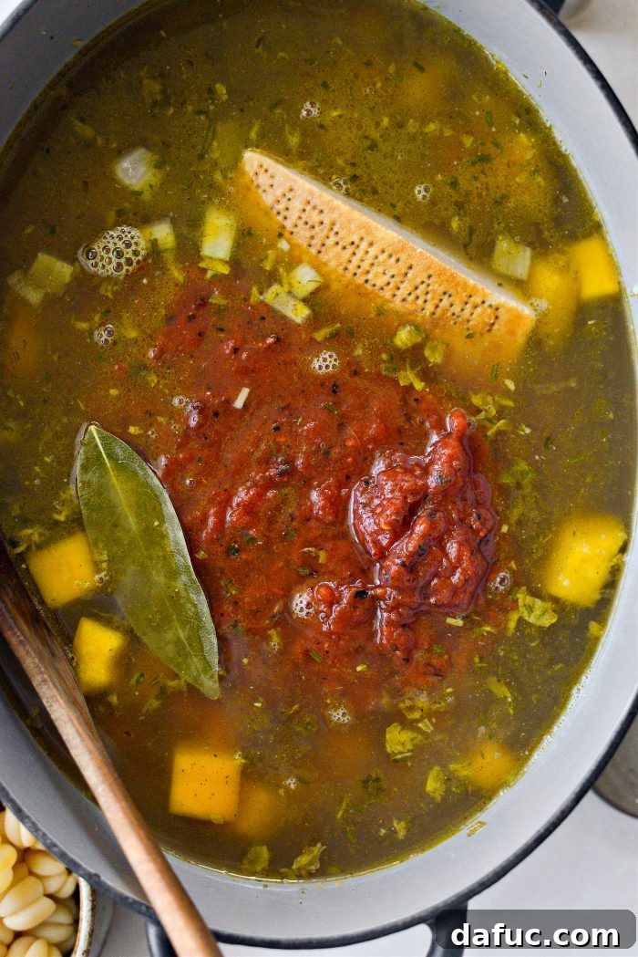 Golden Autumn Pumpkin Minestrone 12 Broth, fire-roasted tomatoes, parmesan rind, and bay leaf added to soup
