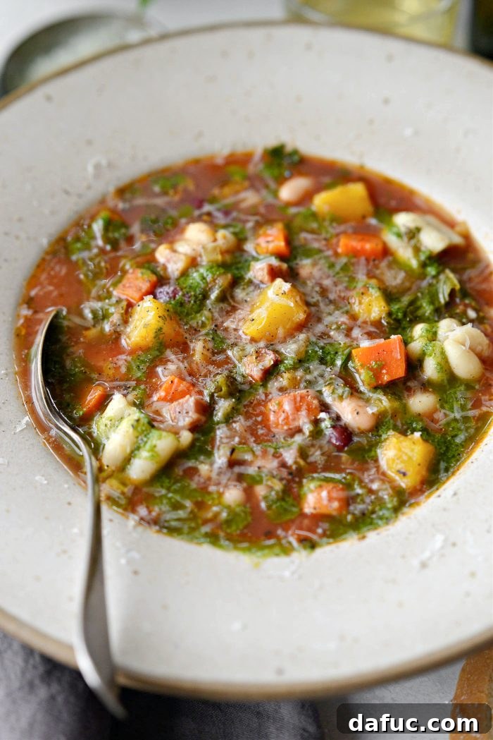 Golden Autumn Pumpkin Minestrone 3 Pumpkin Minestrone served in bowls, garnished with basil oil and parmesan