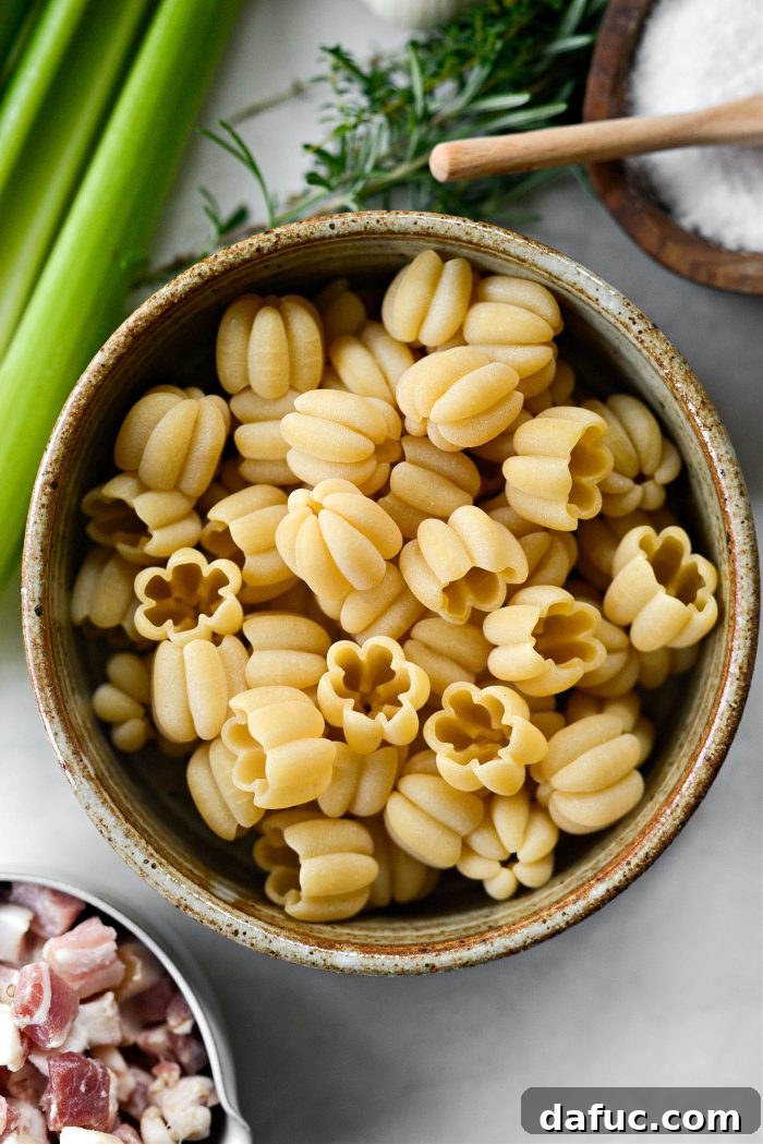 Golden Autumn Pumpkin Minestrone 5 Uncooked pumpkin-shaped zucca pasta in a bowl