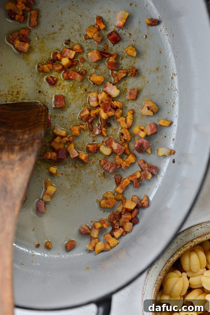 Golden Autumn Pumpkin Minestrone 7 Crispy pancetta in a pan, cooked to perfection