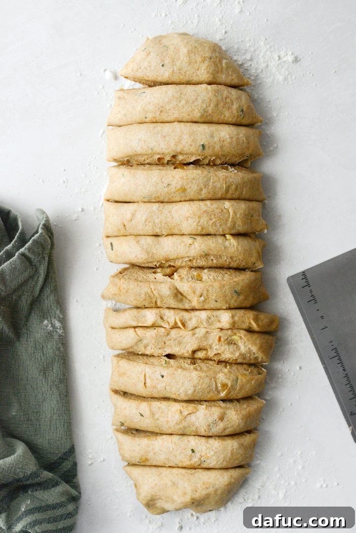 Fragrant Rosemary and Sweet Caramelized Onion Whole Wheat Rolls 21 shape into a 12-inch log and cut into 12 1-inch pieces