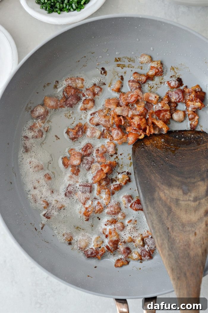 Fluffy Bacon Gruyere Clouds 5 crisped bacon pieces in skillet