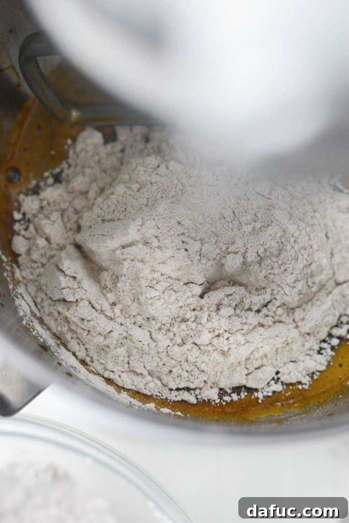 Gradually adding dry ingredients to wet mixture