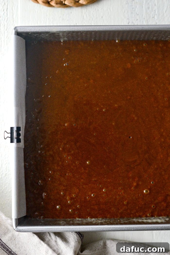 Sliding cake pan into oven to bake