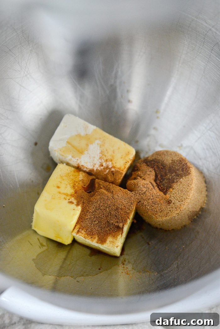 Cream cheese, butter, cinnamon, nutmeg, and brown sugar in a mixing bowl