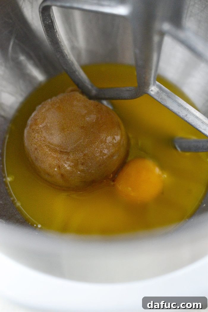 Melted butter, brown sugar, and egg in a mixing bowl