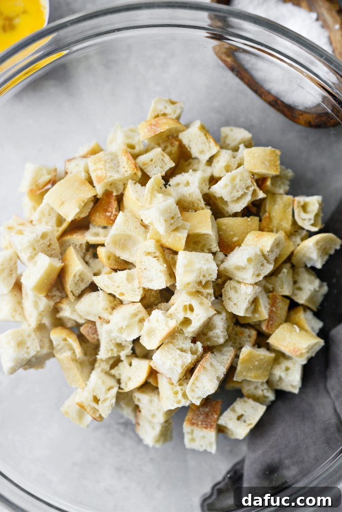 Gourmet Leek and Wild Mushroom Stuffing 8 Cubed baguette pieces in a large mixing bowl, ready for stuffing mixture