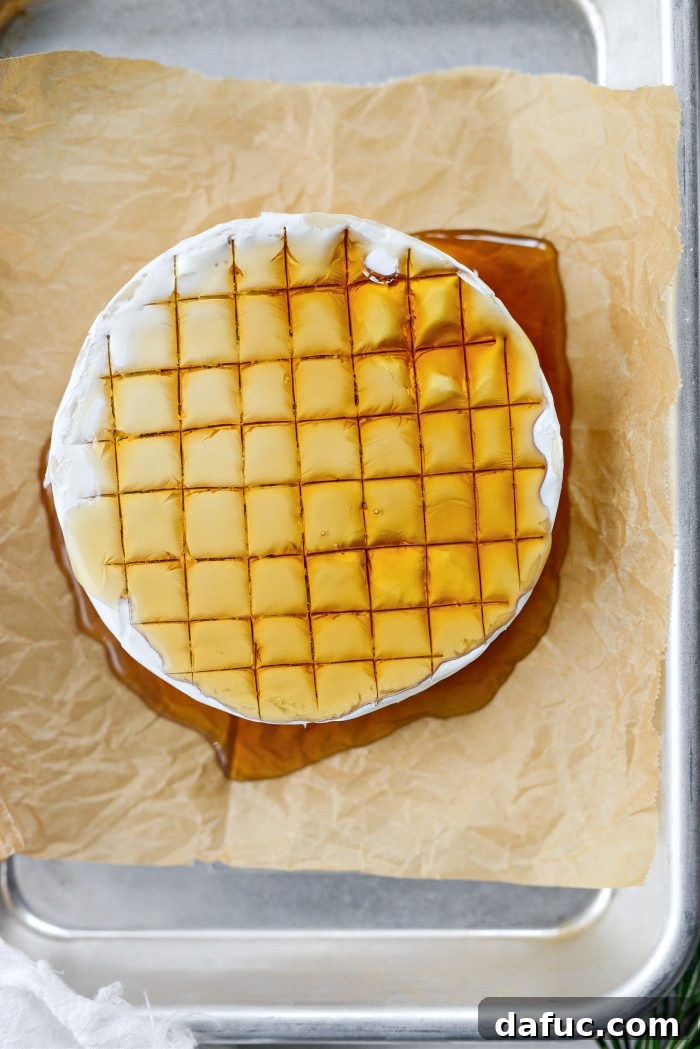 Golden Maple-Drizzled Brie with Ruby Cranberry Swirl 12 Maple baked brie baking in the oven