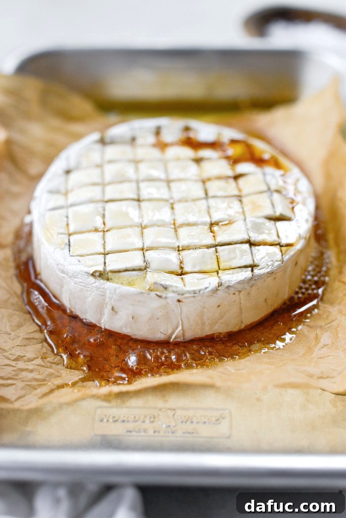 Golden Maple-Drizzled Brie with Ruby Cranberry Swirl 13 Freshly baked maple brie on a baking sheet, ready for serving