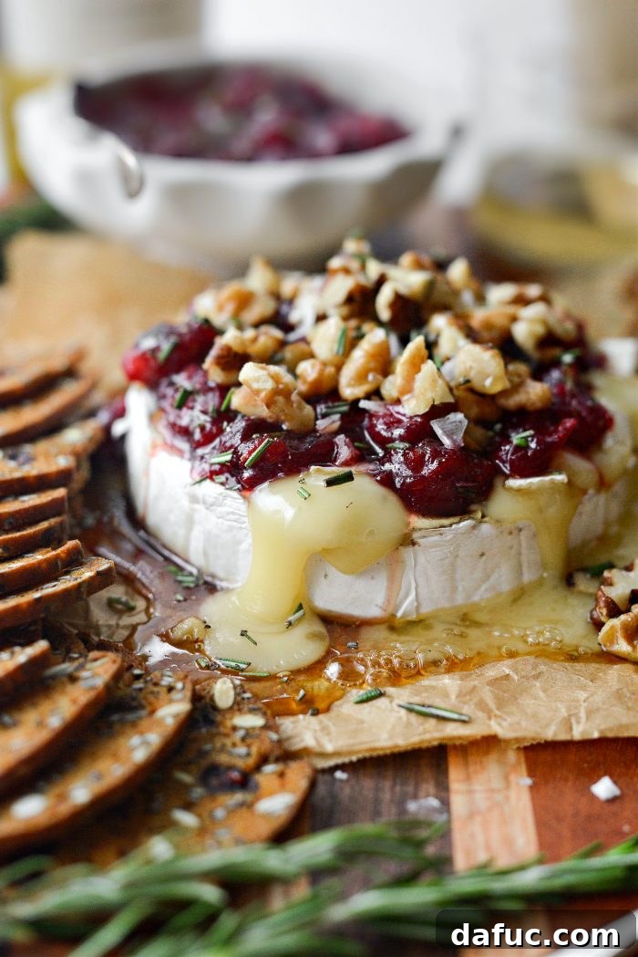 Golden Maple-Drizzled Brie with Ruby Cranberry Swirl 3 Close-up of Maple Baked Brie with Cranberry Jam served on a platter
