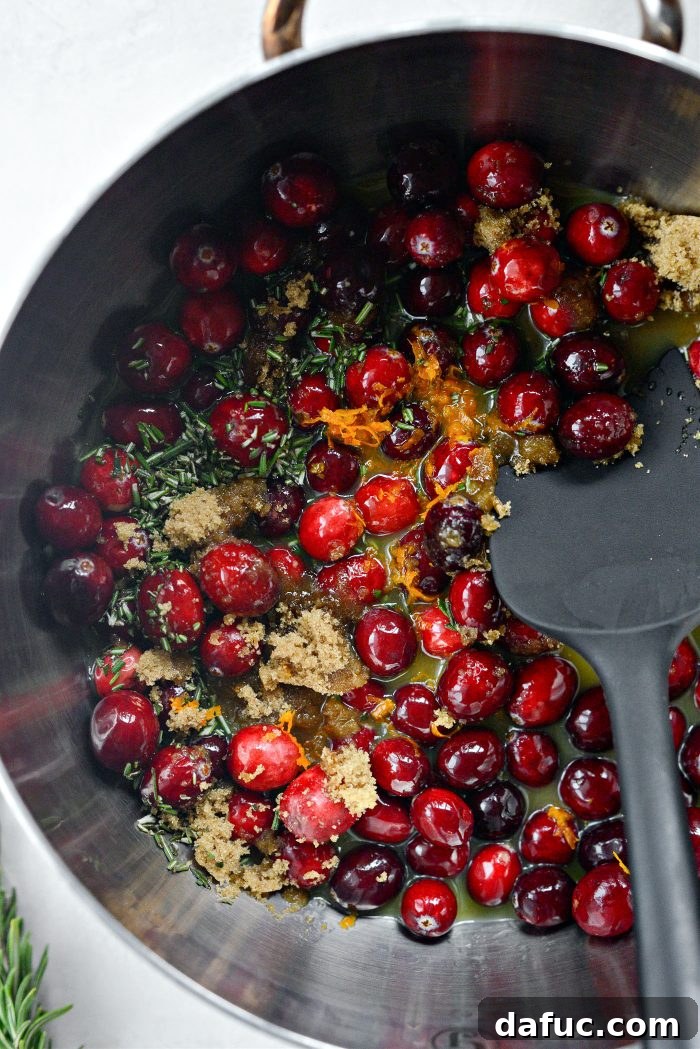 Golden Maple-Drizzled Brie with Ruby Cranberry Swirl 7 Stirring cranberries and other ingredients in a saucepan to simmer