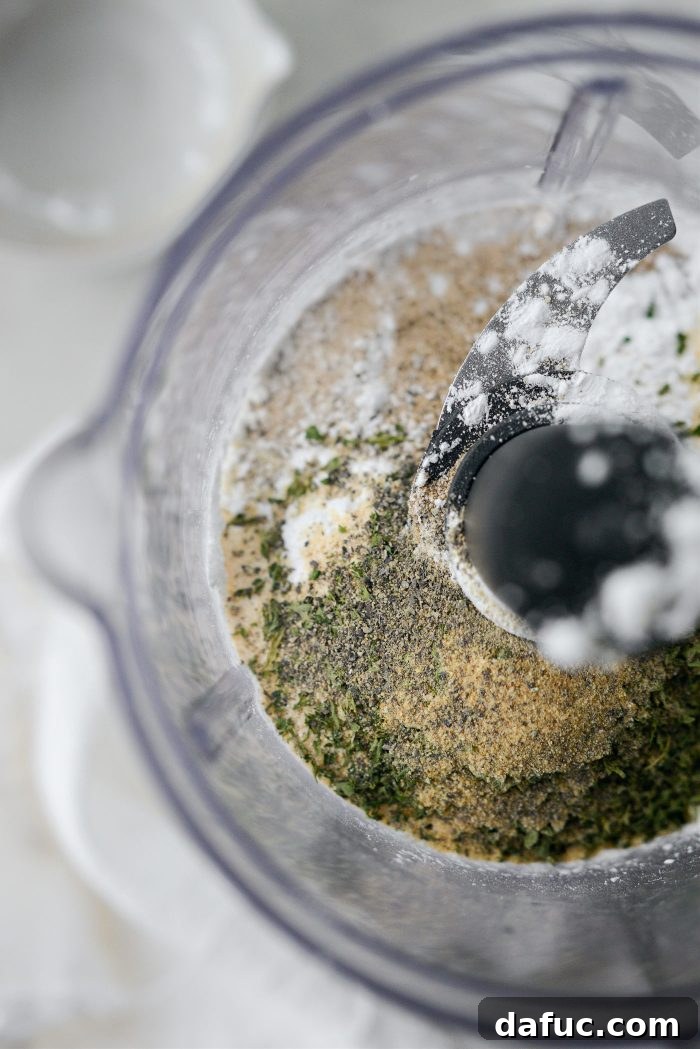 Adding measured ingredients into a mini food processor for Au Jus Gravy Mix