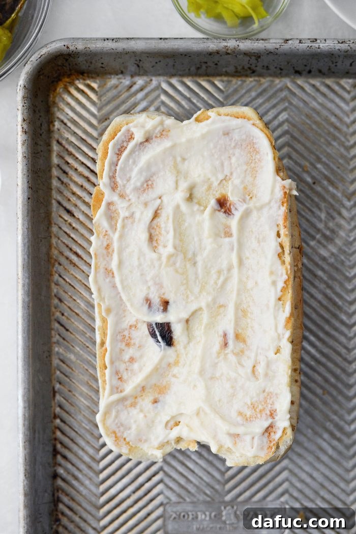 Roasted garlic aioli spread generously on a toasted sub bun.