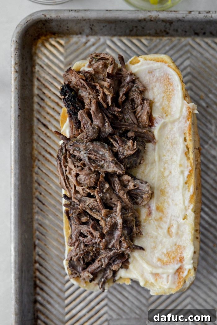 Warm shredded Mississippi pot roast piled onto a toasted sub bun with aioli.