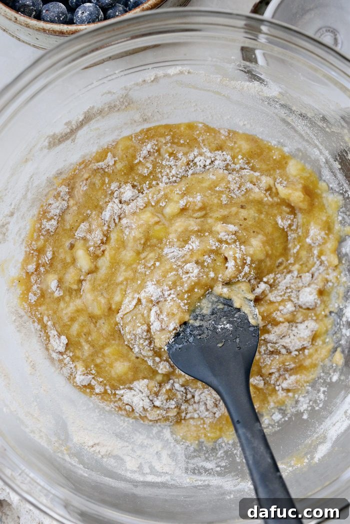 Dry ingredients gradually being added to wet ingredients
