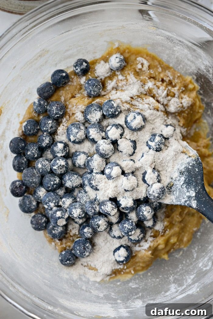 Blueberries being added into the banana bread batter