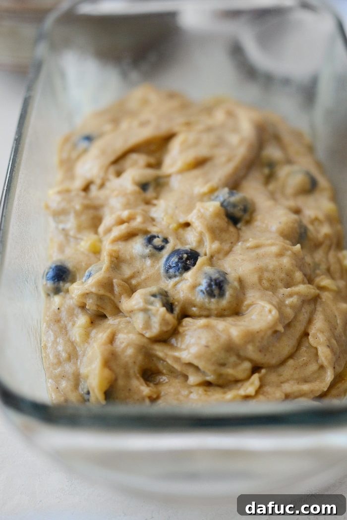 Banana bread batter transferred to a prepared loaf pan