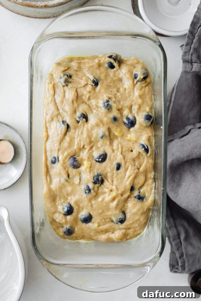 Banana bread batter smoothed in loaf pan, ready for baking