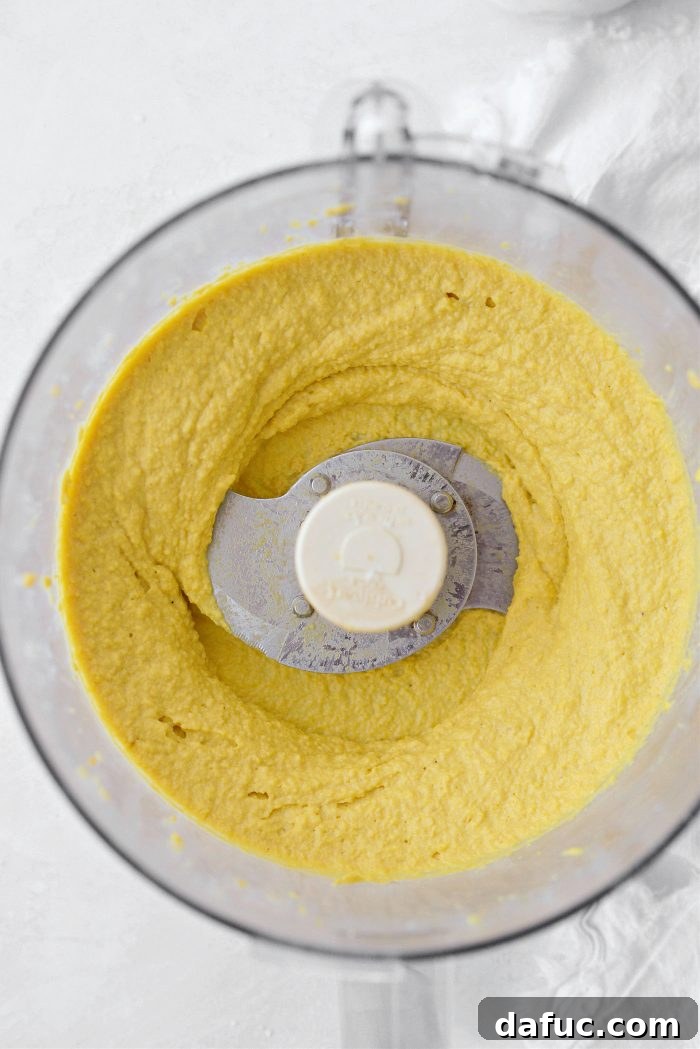 Smooth and creamy Golden Beet Hummus in the food processor, perfectly blended