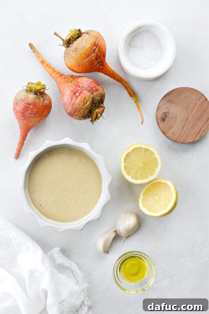 Ingredients for Golden Beet Hummus laid out: golden beets, garlic, olive oil, lemon, tahini, salt, za'atar