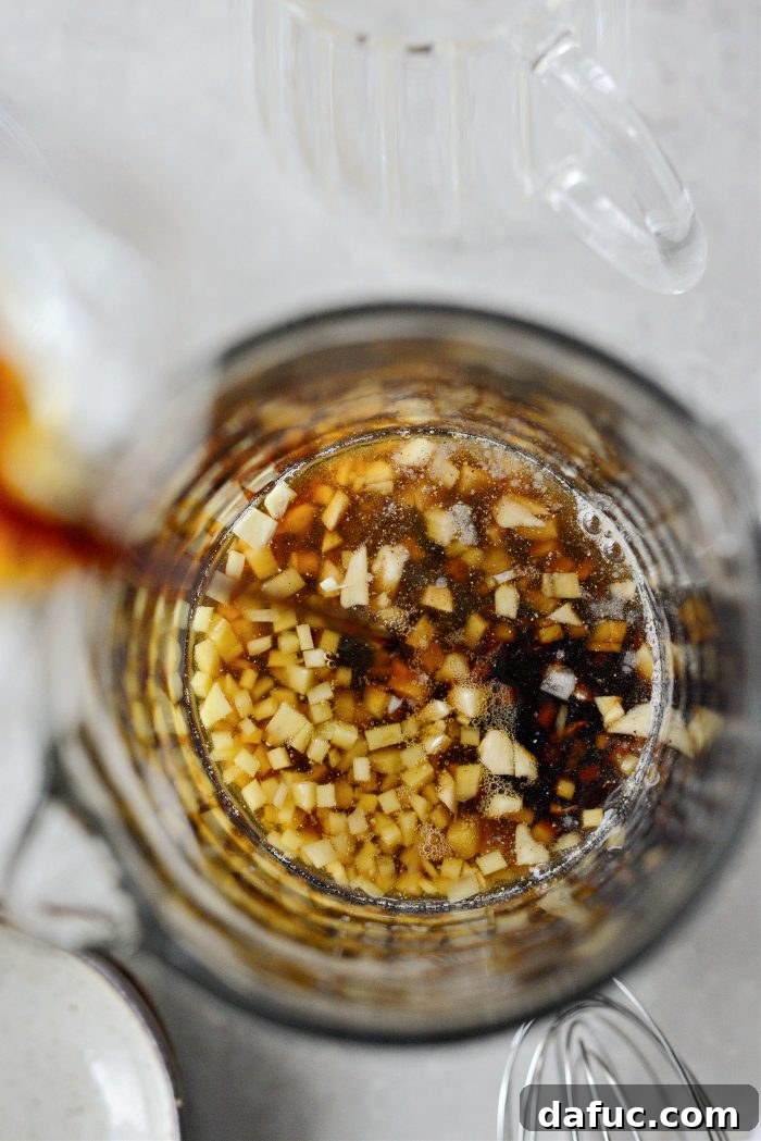 DIY Teriyaki Perfection 5 Pouring soy sauce and mirin into a bowl of dry ingredients for teriyaki sauce